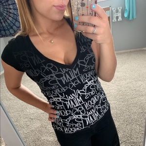 Black vneck with travel destinations by BEBE